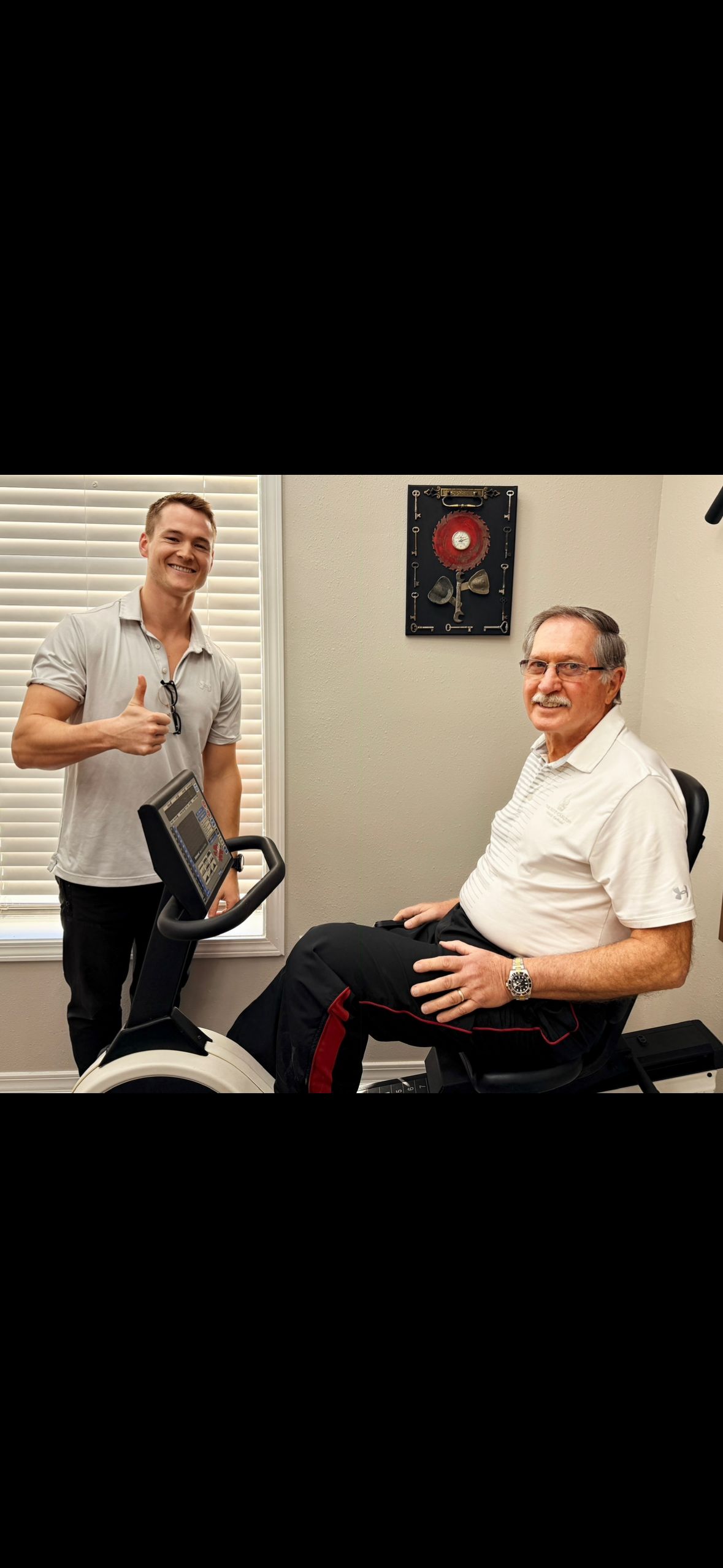 Austin Baskin PT DPT with patient — GT Physical Therapy workers comp rehab Pascagoula MS