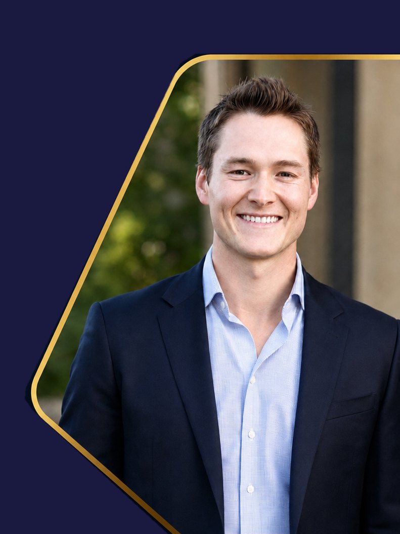 Austin Baskin, PT, DPT, CSCS, Cert DN, in a navy suit jacket