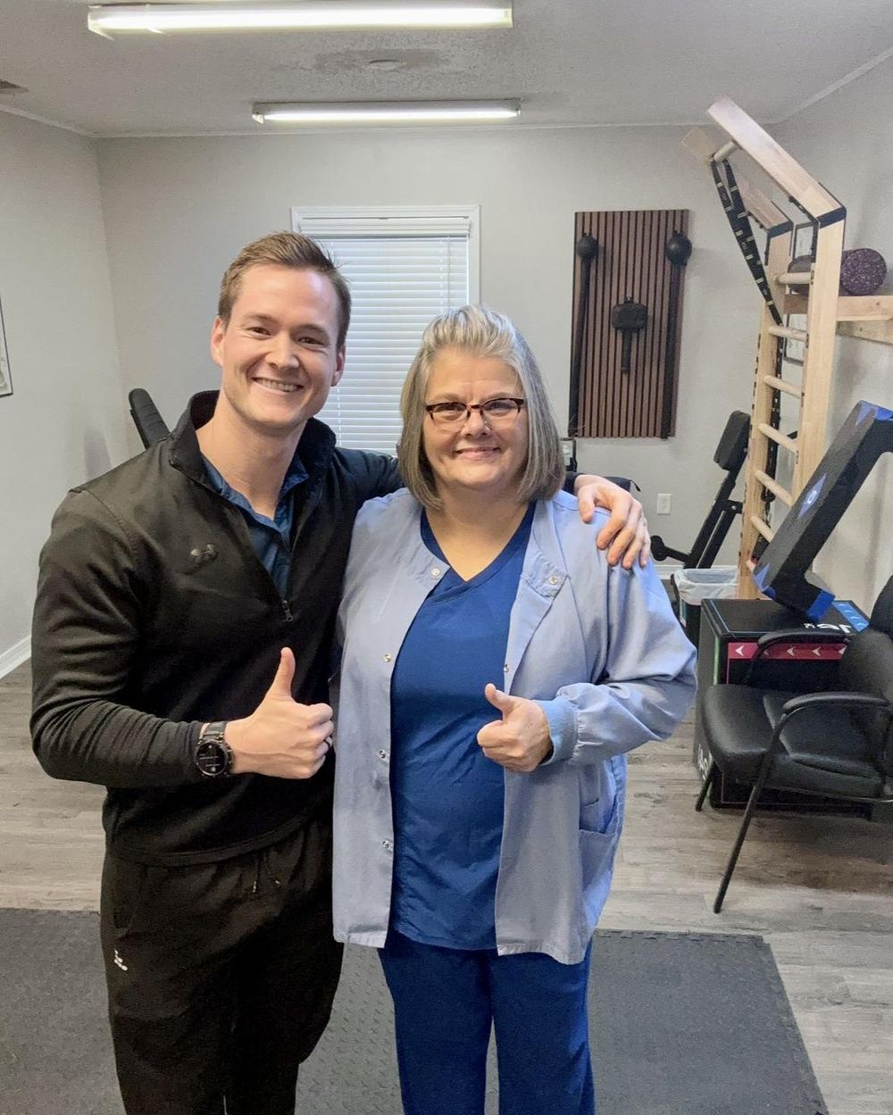 Dr. Austin Baskin and a patient smiling together in the clinic